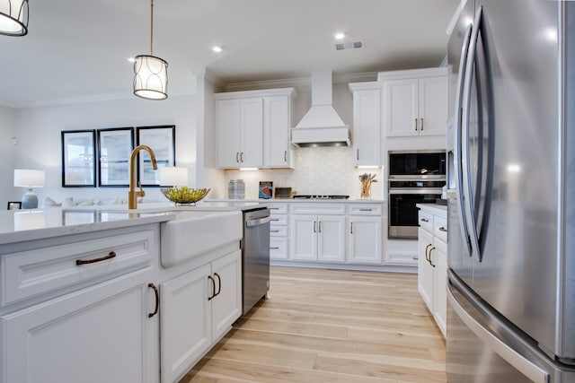 kitchen featuring white cabinetry, hanging light fixtures, stainless steel appliances, and custom exhaust hood