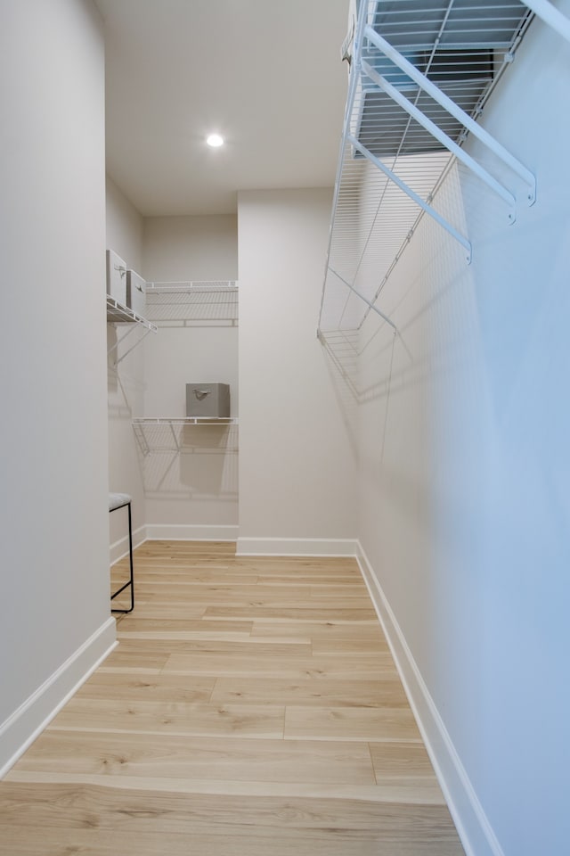 walk in closet featuring light hardwood / wood-style floors