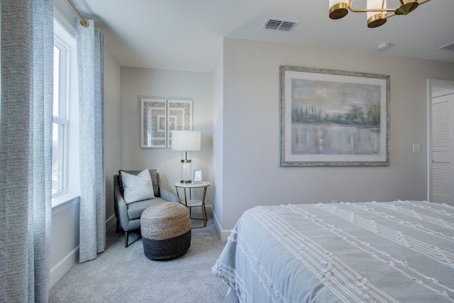 bedroom with multiple windows, carpet floors, and ceiling fan with notable chandelier