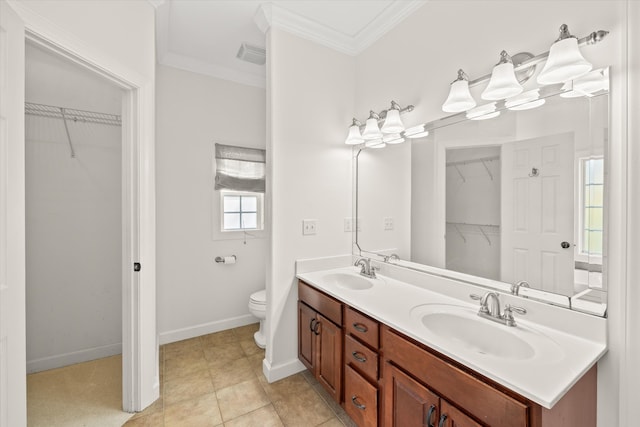 bathroom with toilet, vanity, tile patterned floors, and ornamental molding