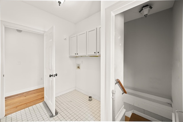 laundry area featuring cabinets, hookup for a washing machine, and light wood-type flooring