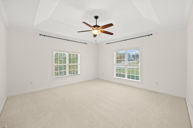 carpeted spare room with ceiling fan, a healthy amount of sunlight, and crown molding