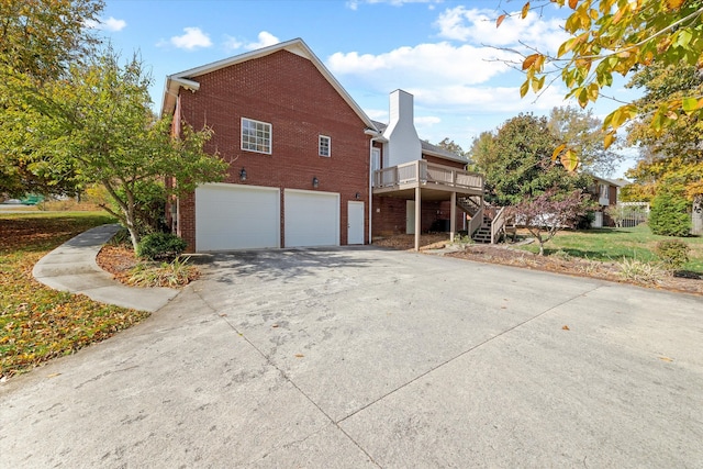 view of side of home with a deck and a garage