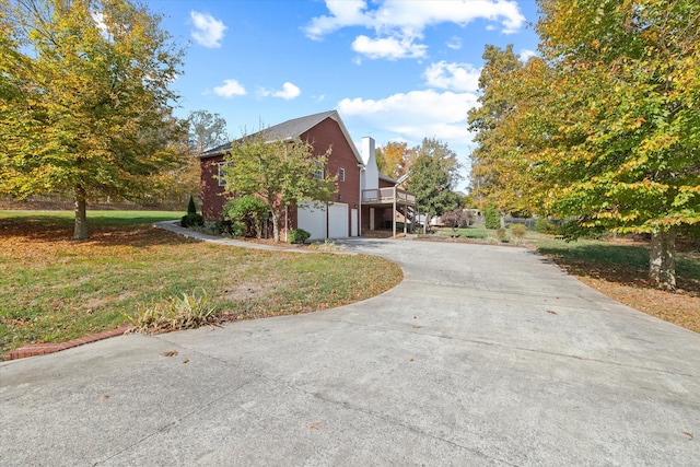 view of side of home featuring a garage and a yard