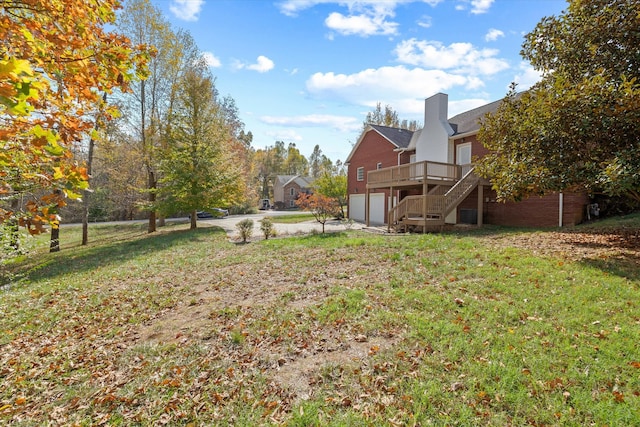 view of yard with a garage and a deck