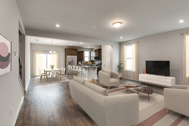 living room featuring dark hardwood / wood-style flooring and a notable chandelier