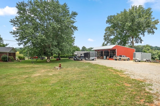 view of yard featuring an outdoor structure and a carport