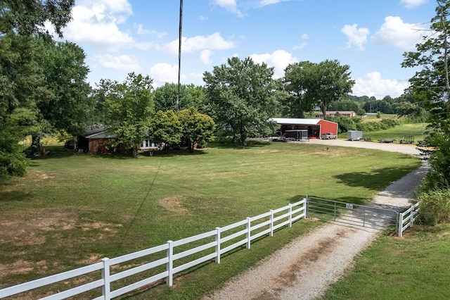 view of yard featuring a storage shed and a rural view