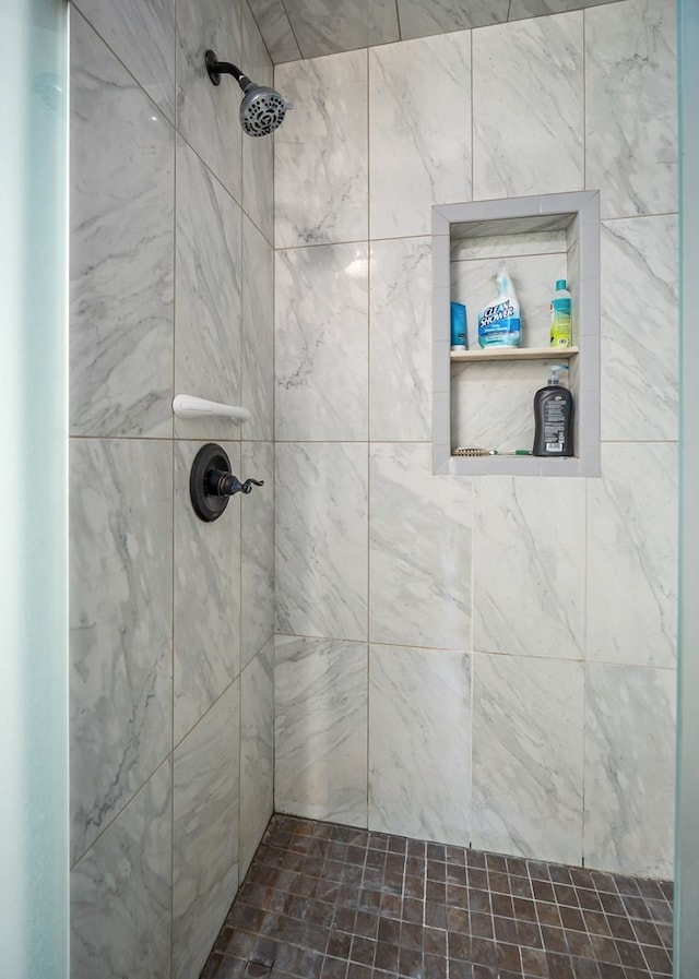 bathroom with tiled shower