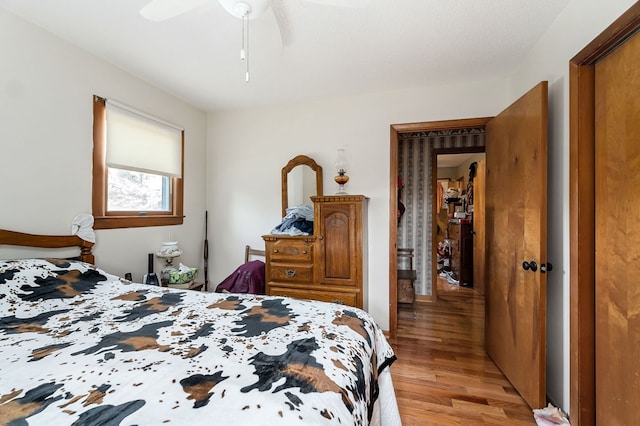 bedroom with light hardwood / wood-style floors and ceiling fan