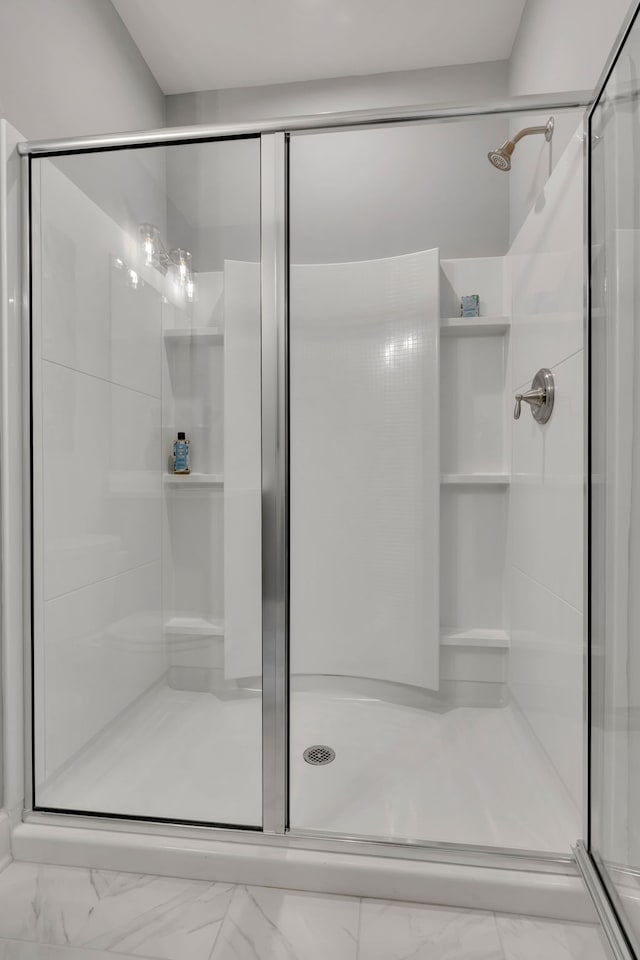 bathroom with a shower with shower door