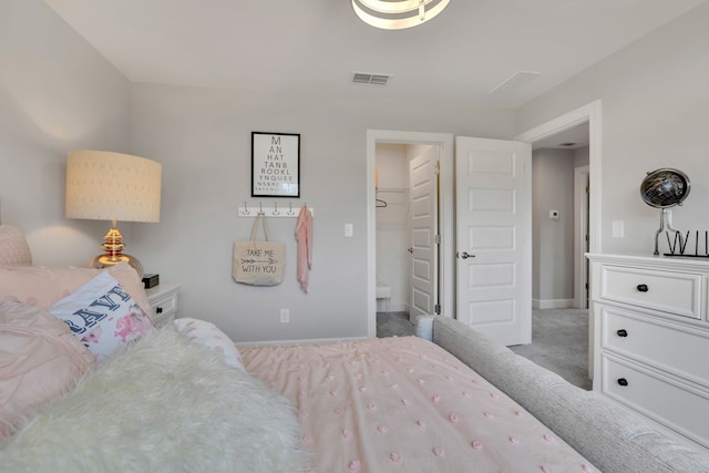 bedroom with light colored carpet, a walk in closet, and a closet