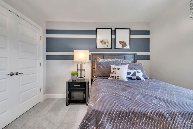 bedroom featuring light colored carpet and a closet