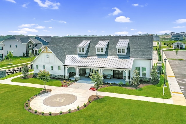 rear view of house featuring a lawn