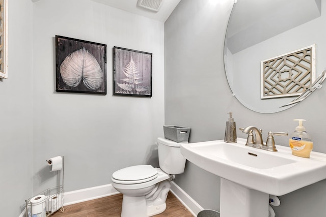 bathroom featuring hardwood / wood-style floors, toilet, and sink