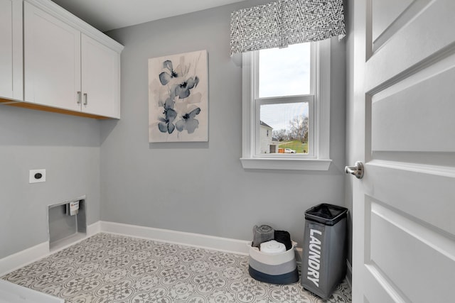 laundry area featuring electric dryer hookup and cabinets