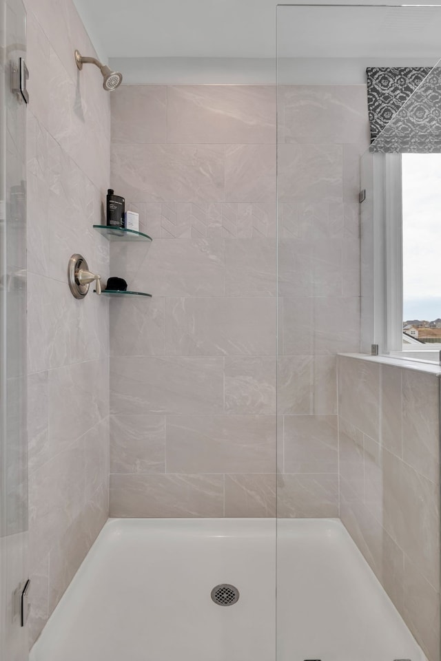 bathroom with a tile shower