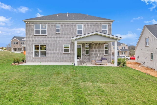 rear view of house featuring a lawn, outdoor lounge area, and a patio