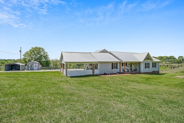 ranch-style home featuring a porch, a front lawn, and a shed