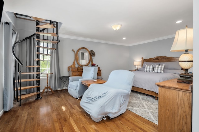 bedroom with hardwood / wood-style flooring and crown molding