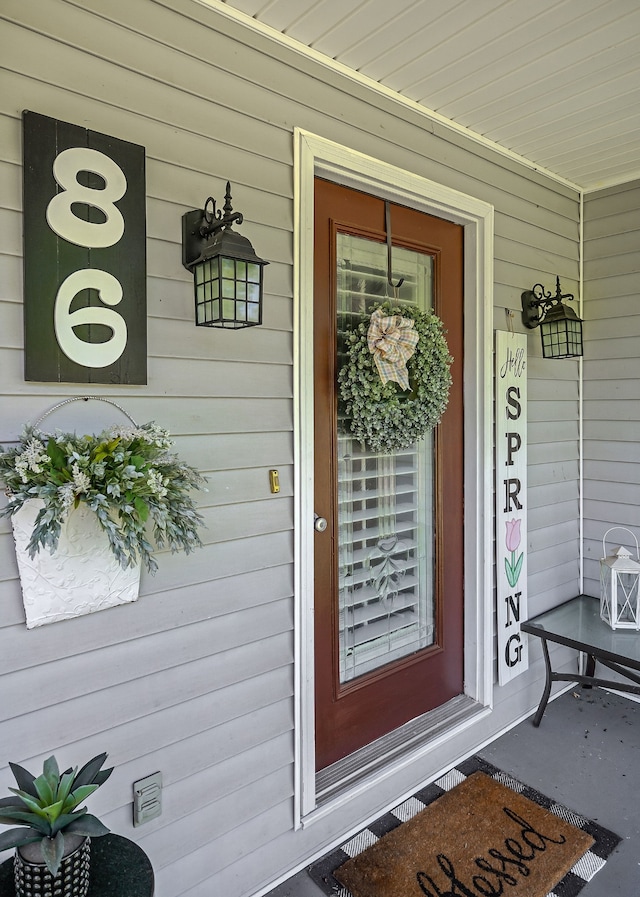 view of exterior entry with covered porch