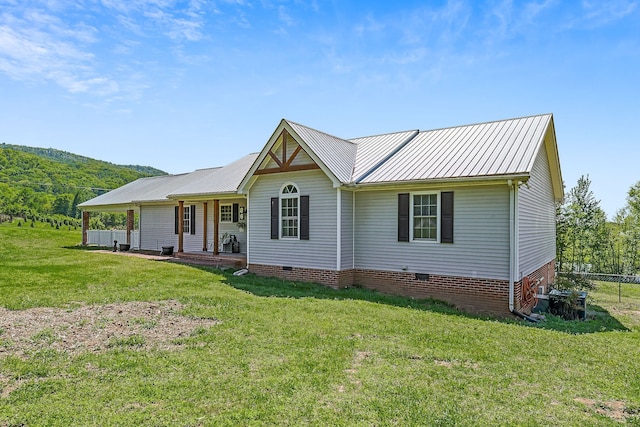 rear view of house featuring a lawn and a mountain view