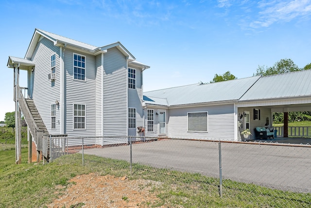 exterior space featuring a yard and a carport