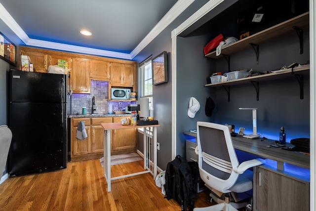 office with sink, light wood-type flooring, and ornamental molding