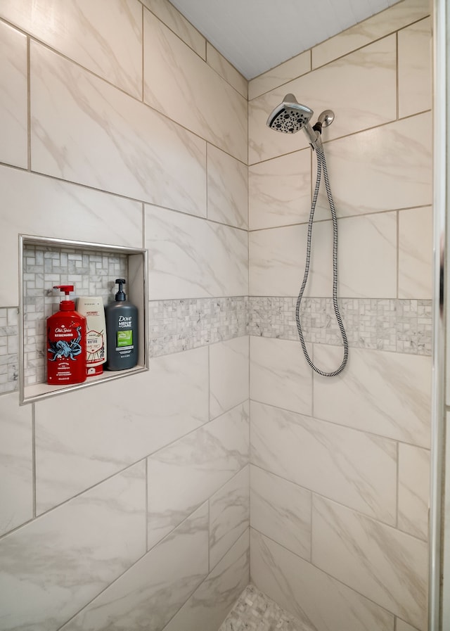 bathroom with a tile shower