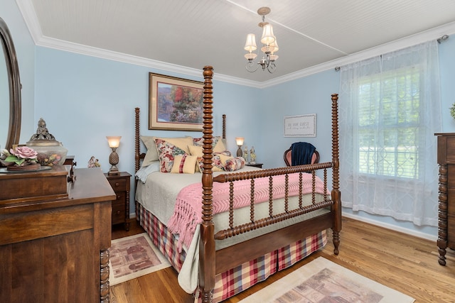 bedroom with ornamental molding, hardwood / wood-style floors, and a notable chandelier