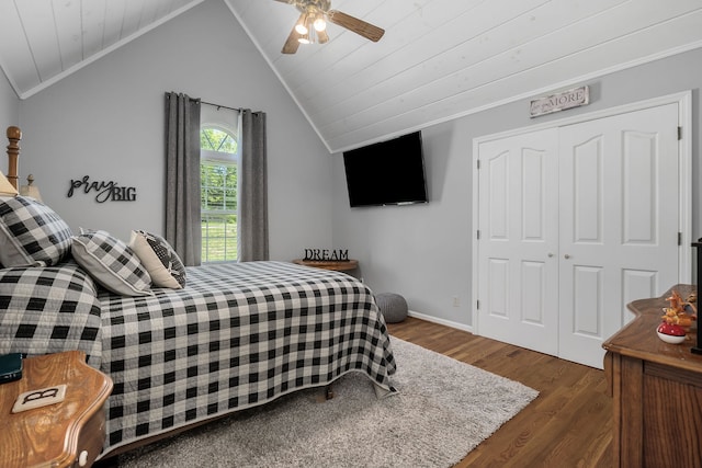 bedroom with ornamental molding, ceiling fan, dark hardwood / wood-style floors, a closet, and vaulted ceiling