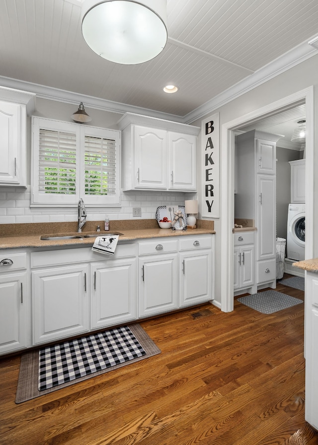 kitchen featuring white cabinets, dark hardwood / wood-style floors, sink, and washer / clothes dryer