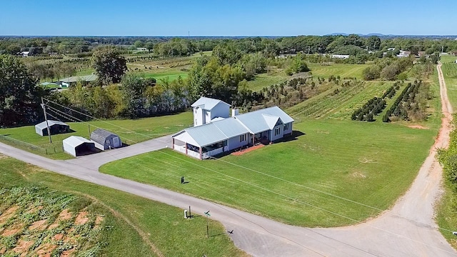 birds eye view of property with a rural view