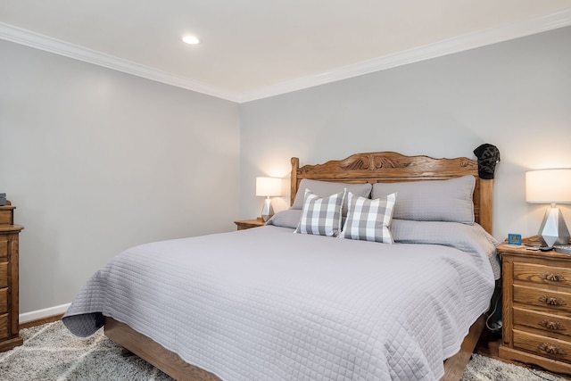 bedroom featuring ornamental molding and hardwood / wood-style floors