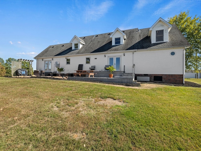 back of property with a lawn and a deck