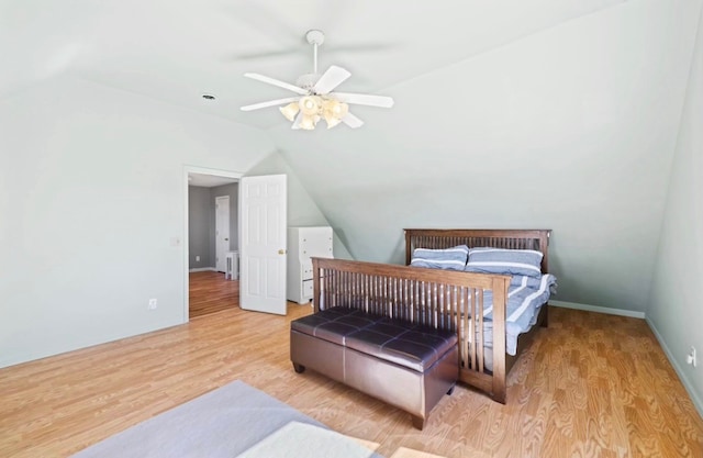 bedroom featuring light wood-type flooring, lofted ceiling, and ceiling fan