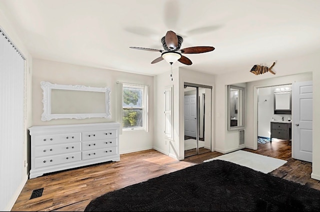 unfurnished bedroom featuring hardwood / wood-style flooring, ceiling fan, and sink