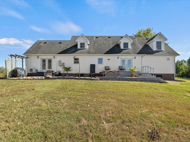 back of property with a yard and french doors