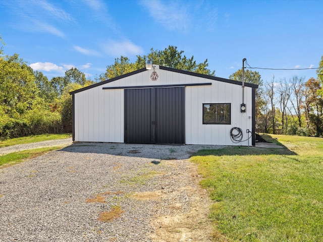 view of outbuilding with a lawn