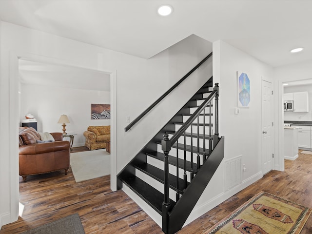 stairs with hardwood / wood-style floors