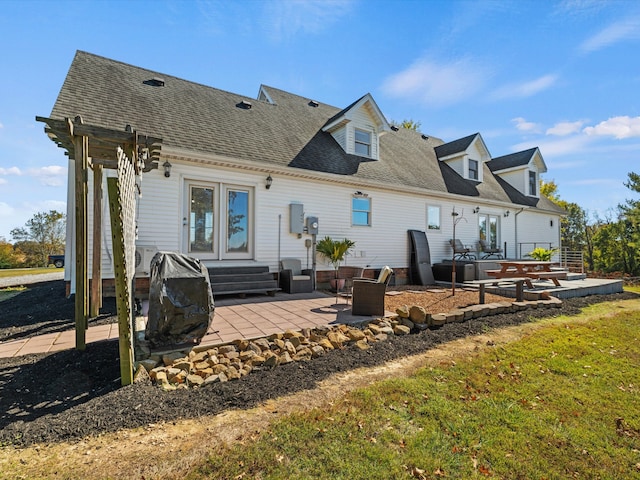 back of house with a patio area and a yard