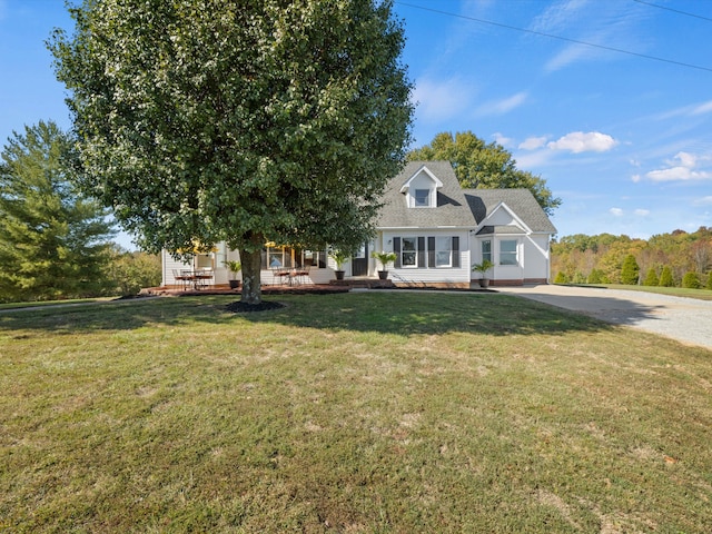 new england style home with a porch and a front yard