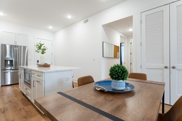 dining area with light wood-type flooring