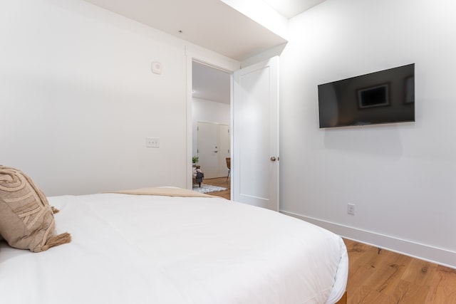 bedroom with wood-type flooring