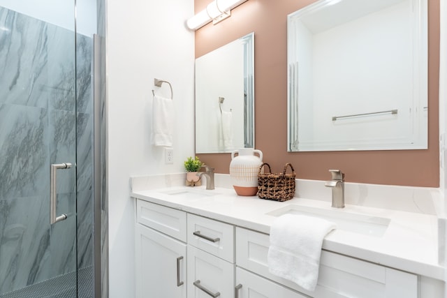 bathroom with vanity and a shower with door