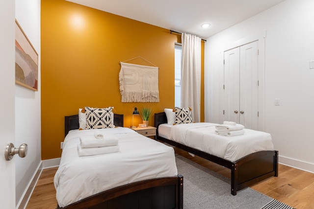 bedroom with a closet and light hardwood / wood-style flooring