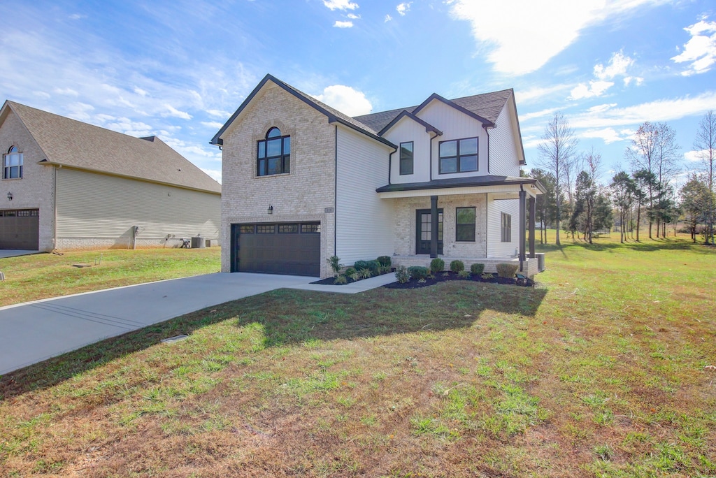 view of front of property featuring a garage and a front lawn