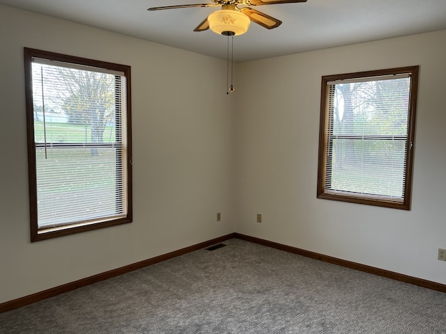 carpeted spare room with ceiling fan