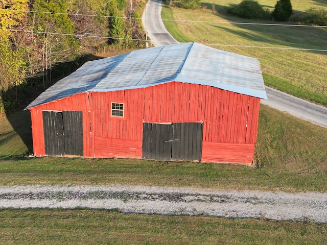 view of outbuilding featuring a yard