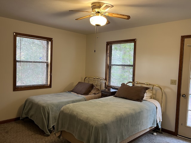 bedroom featuring carpet flooring, multiple windows, and ceiling fan